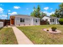 A well-maintained home with a tidy front yard and a welcoming walkway, great for suburban living at 1023 Hooker St, Denver, CO 80204