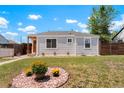 Quaint single-story home with a manicured lawn and colorful rock accents creating an inviting curb appeal at 1023 Hooker St, Denver, CO 80204
