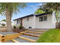 Beautifully renovated home with wooden retaining walls and well-manicured landscaping around the property at 5573 S Huron St, Littleton, CO 80120