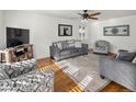 Living room featuring hardwood floors, a ceiling fan, and comfortable seating at 6631 E Ithaca Pl, Denver, CO 80237