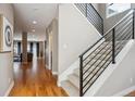 Spacious hallway featuring hardwood floors, a modern staircase, and neutral paint at 2122 S Ogden St, Denver, CO 80210