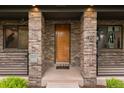 Close-up of the front entrance with a modern wood door and brick columns at 1927 S Grant St, Denver, CO 80210