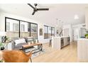 Open concept living and kitchen area with light wood floors and modern design at 3433 Lawrence St # 1, Denver, CO 80205