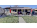 Charming ranch home with covered porch and landscaped yard at 6651 Albion St, Commerce City, CO 80022