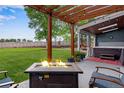 Relaxing patio with fire pit, hot tub, and pergola at 10399 Zenobia Ct, Westminster, CO 80031