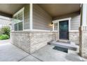 Inviting front porch showcasing brick accents, neutral siding, and a secure front door at 2741 Poplar Grove Pl, Castle Rock, CO 80109