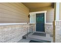 Charming front porch with brick accents, offering a welcoming entry to the home at 2741 Poplar Grove Pl, Castle Rock, CO 80109