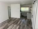 Open-concept living area with updated flooring and a view of the modern kitchen at 2815 S Dexter Way, Denver, CO 80222