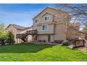 Spacious backyard with a multi-level deck, a lush lawn, and mature trees at 3978 Aspen Hollow Ct, Castle Rock, CO 80104