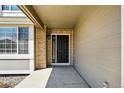 Inviting front entrance with a black door and stylish exterior lighting at 19061 E Powers Pl, Aurora, CO 80015