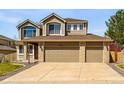 Beautiful two-story home with a three-car garage and manicured front yard at 19061 E Powers Pl, Aurora, CO 80015