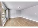 Bright living room featuring hardwood floors, neutral walls, and a large window providing natural light at 5442 S Cedar St, Littleton, CO 80120