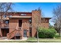 Two-story condo with wood siding, a front porch, stairway and mature landscaping at 540 S Forest St # 5-204, Denver, CO 80246