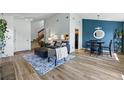 Spacious living room with hardwood floors, modern decor, and an open concept design leading to the dining area at 540 S Forest St # 5-204, Denver, CO 80246
