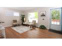 Bright living room with hardwood floors, neutral colors and a large window at 10420 Marion St, Northglenn, CO 80233