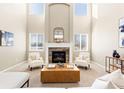 Spacious living room with a fireplace, high ceilings, and ample natural light at 1669 S De Gaulle Way, Aurora, CO 80018