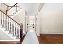 Elegant staircase with dark wood railings leading to the upper level at 1669 S De Gaulle Way, Aurora, CO 80018