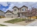 Charming two-story home with a three-car garage and blooming tree at 3508 Silverado Cir, Frederick, CO 80516
