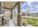 Inviting front porch with stone columns and a view of the neighborhood at 3508 Silverado Cir, Frederick, CO 80516