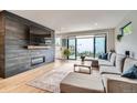 Contemporary living room featuring hardwood floors, modern fireplace, and sliding door to backyard at 3911 Mariposa St, Denver, CO 80211