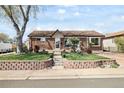Charming brick home with a well-maintained front yard and retaining wall at 10769 Murray Dr, Northglenn, CO 80233