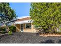 Attractive single-story brick home with manicured landscaping and mature trees, close to the sidewalk at 3430 N Clayton St, Denver, CO 80205