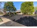 Attractive single-story brick home with neat landscaping and lush trees, set back from the street at 3430 N Clayton St, Denver, CO 80205