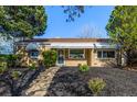 Inviting single-story brick home with charming curb appeal and a freshly landscaped front yard at 3430 N Clayton St, Denver, CO 80205