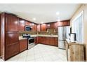 Modern kitchen featuring stainless steel appliances, ample cabinet space, and tiled backsplash at 1930 Altura Blvd, Aurora, CO 80011