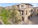 Close-up of attractive home with stone and stucco, showcasing front entry with lovely landscaping and a two-car garage at 3291 Cascina Cir # D, Highlands Ranch, CO 80126