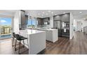 Modern kitchen featuring stainless steel appliances, large island and granite countertops at 12017 W 54Th Dr, Arvada, CO 80002