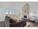 Bright living room with large windows, fireplace, and stylish decor at 12017 W 54Th Dr, Arvada, CO 80002