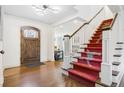 Entryway featuring hardwood floors and a staircase with red leopard print runner at 10 Cherry St, Denver, CO 80220