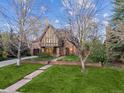 Charming Tudor-style home with well-kept front yard and stone pathway leading to the front door at 10 Cherry St, Denver, CO 80220