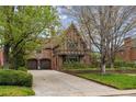 Brick home with arched garage doors and driveway with basketball hoop at 10 Cherry St, Denver, CO 80220
