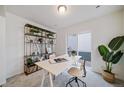 Modern home office with a large desk, built-in shelving, and backyard access at 45008 Sunflower Ln, Bennett, CO 80102