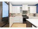 Bright kitchen boasts white cabinetry, modern appliances, and a stylish backsplash at 3924 Alamosa Ct, Brighton, CO 80601