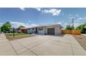 Charming single-story home with an attached garage, newly done driveway, and fenced in yard at 235 N 12Th Ave, Brighton, CO 80601