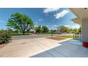 Expansive front yard view showcasing a neighborhood park with mature trees and a sidewalk at 235 N 12Th Ave, Brighton, CO 80601
