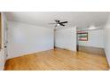 Bright and airy living room with hardwood floors, white walls, and a modern ceiling fan at 235 N 12Th Ave, Brighton, CO 80601