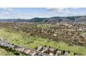 Beautiful aerial view of a neighborhood with homes and lush green spaces near mountains at 7141 Red Mesa Dr, Littleton, CO 80125