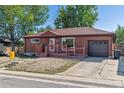 Ranch style brick home with a carport and landscaping at 1104 Elmer Dr, Northglenn, CO 80233