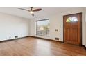 Bright living room with hardwood floors and ceiling fan at 1104 Elmer Dr, Northglenn, CO 80233