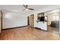 Open concept living room with hardwood floors and kitchen view at 1104 Elmer Dr, Northglenn, CO 80233