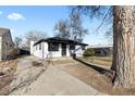 Charming single story home with neutral paint, landscaped yard and long driveway at 1973 Alton St, Aurora, CO 80010