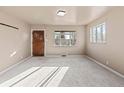 Bright living room featuring fresh neutral paint, large window and carpet at 1973 Alton St, Aurora, CO 80010