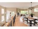 Open-concept living area with hardwood floors, natural light, and a fireplace at 2940 Ulster St, Denver, CO 80238
