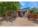Charming brick home with blue shutters and a cozy front porch at 2692 S Pennsylvania St, Denver, CO 80210
