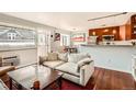 Cozy living room with hardwood floors, modern decor, and an adjacent eat-in kitchen at 500 E 11Th Ave # 305, Denver, CO 80203