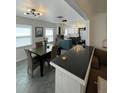 Bright dining room with open view of kitchen, modern fixtures, and cozy seating at 4995 N Beach Ct, Denver, CO 80221